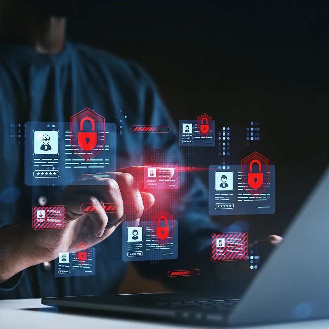 Eine Hand klickt auf Hologramme vor einem aufgeklappten Laptop.